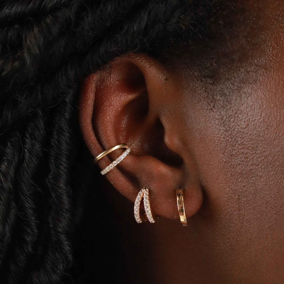 Illusion Crystal Huggies in Gold worn with Illusion Crystal Ear Cuff and a gold huggie